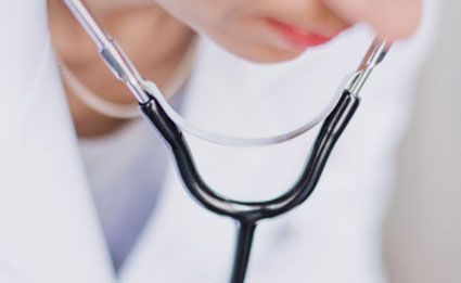 closeup of doctor using a stethoscope